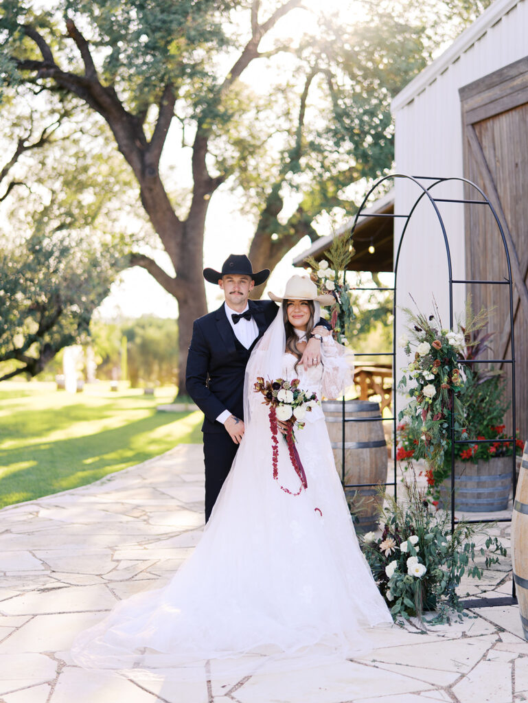 Bride and groom embracing at The Adelphia during a romantic southern wedding editorial, surrounded by lush florals and timeless charm