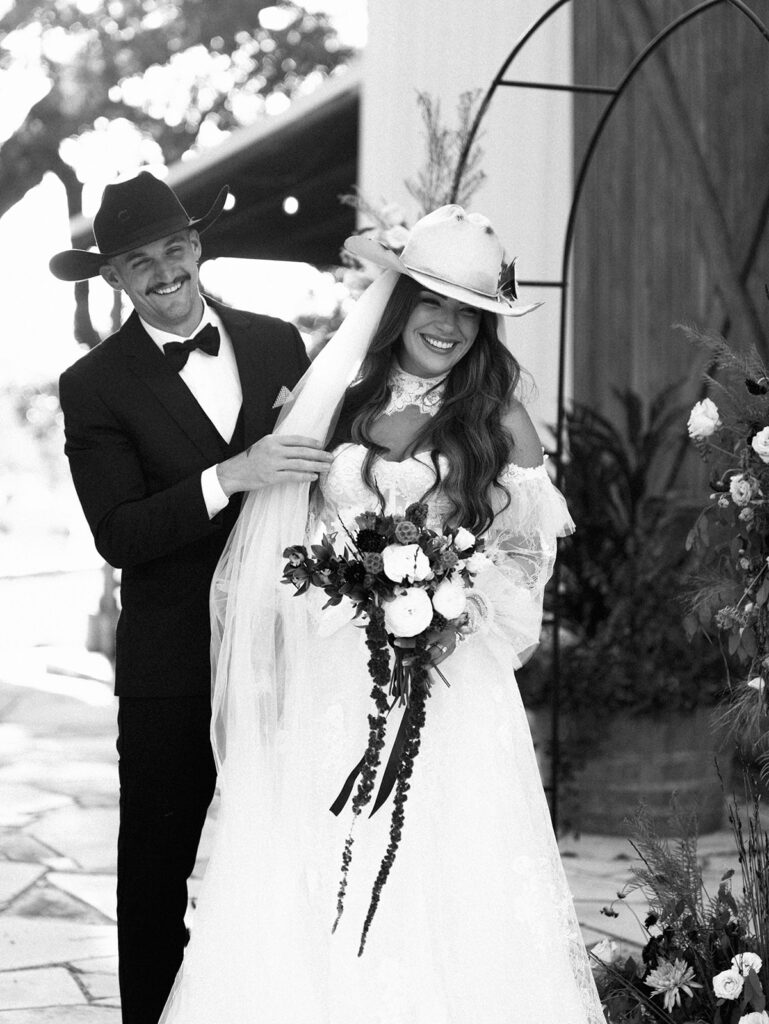 Bride and groom at The Adelphia wedding editorial in Lampasas, TX, surrounded by romantic florals and southern charm