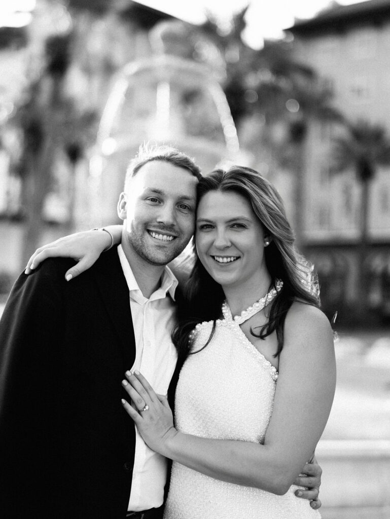 Candid laughter by the ocean at golden hour during Emma and Luke’s film engagement session at the Grand Galvez.