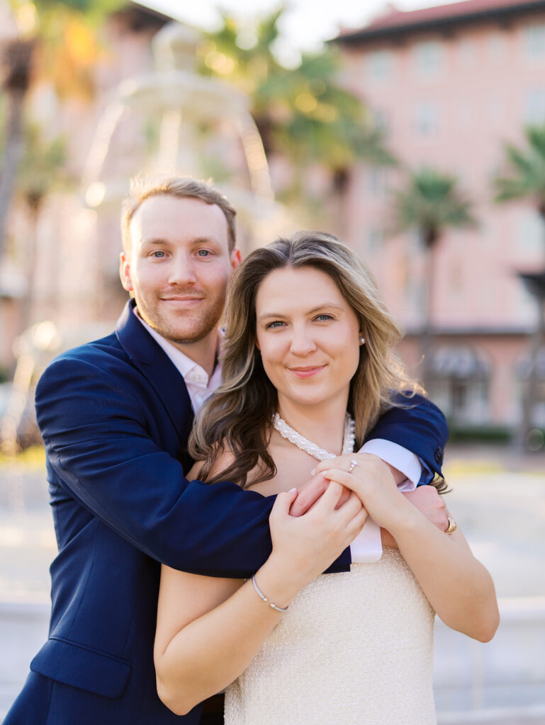Candid laughter by the ocean at golden hour during Emma and Luke’s film engagement session at the Grand Galvez.