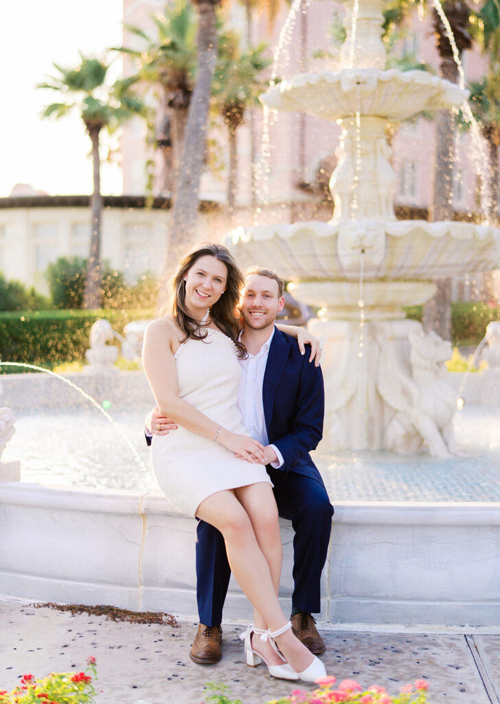 Candid laughter by the ocean at golden hour during Emma and Luke’s film engagement session at the Grand Galvez.