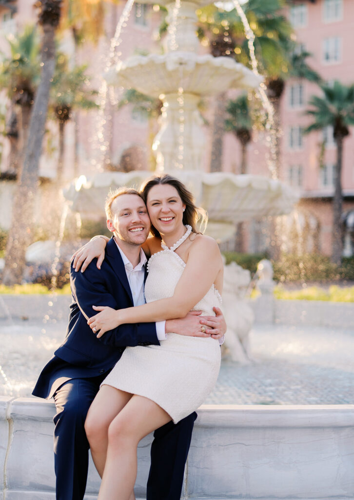 Candid laughter by the ocean at golden hour during Emma and Luke’s film engagement session at the Grand Galvez.