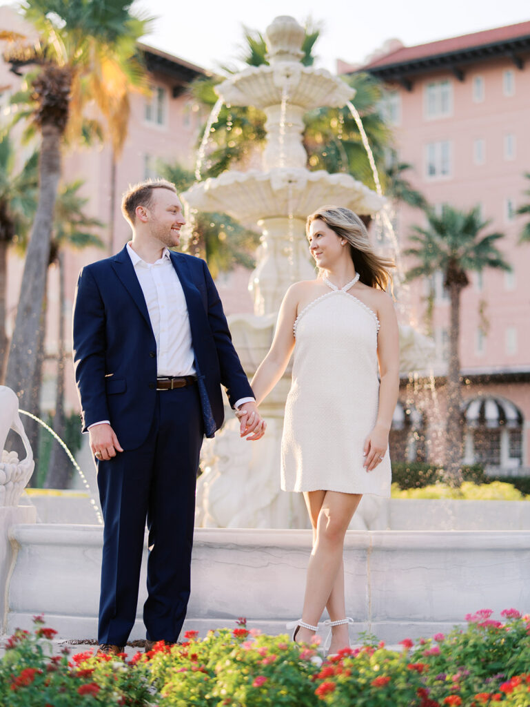 Candid laughter by the ocean at golden hour during Emma and Luke’s film engagement session at the Grand Galvez.
