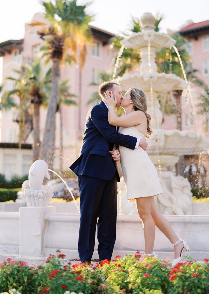 Candid laughter by the ocean at golden hour during Emma and Luke’s film engagement session at the Grand Galvez.