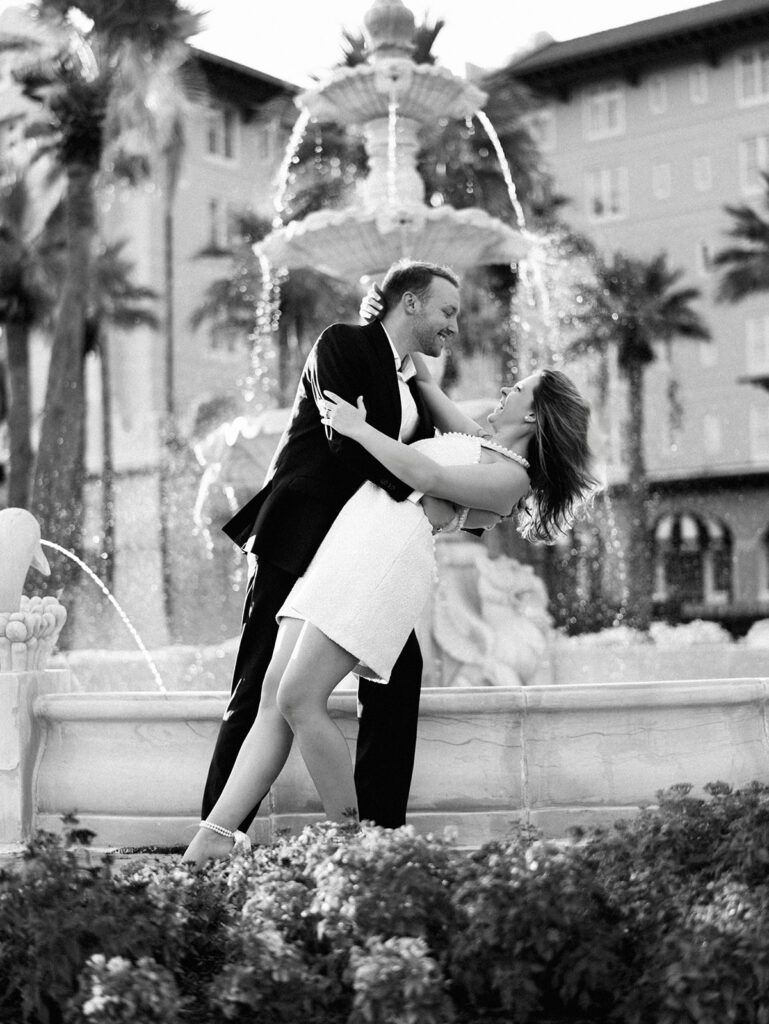 Emma twirling under palm trees while Luke smiles with vibrant timeless color captured on film