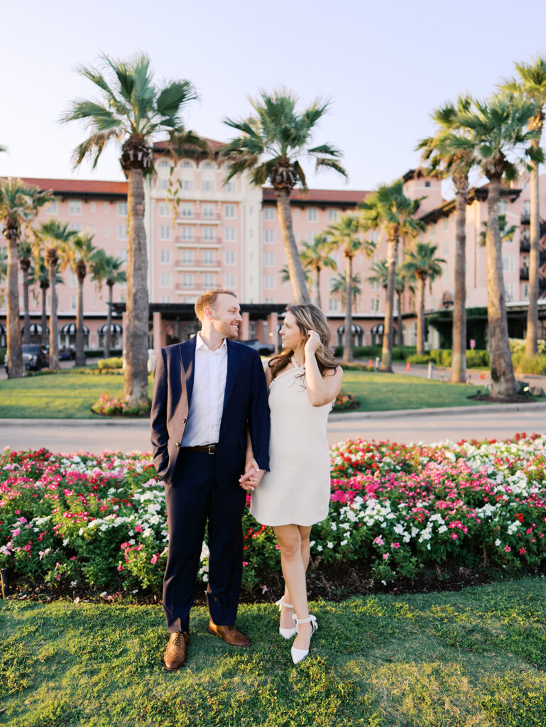 Emma twirling under palm trees while Luke smiles with vibrant timeless color captured on film