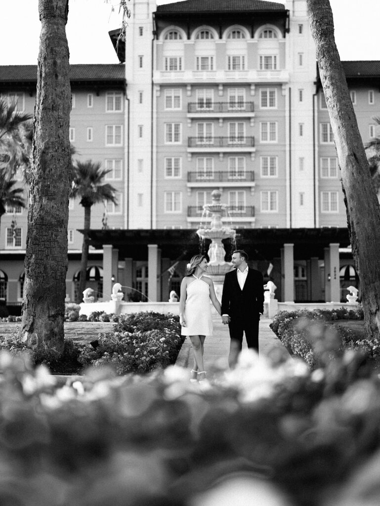 Emma twirling under palm trees while Luke smiles with vibrant timeless color captured on film