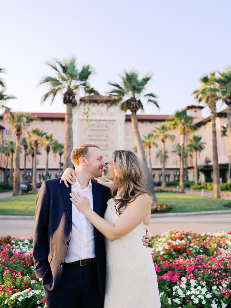 Emma twirling under palm trees while Luke smiles with vibrant timeless color captured on film
