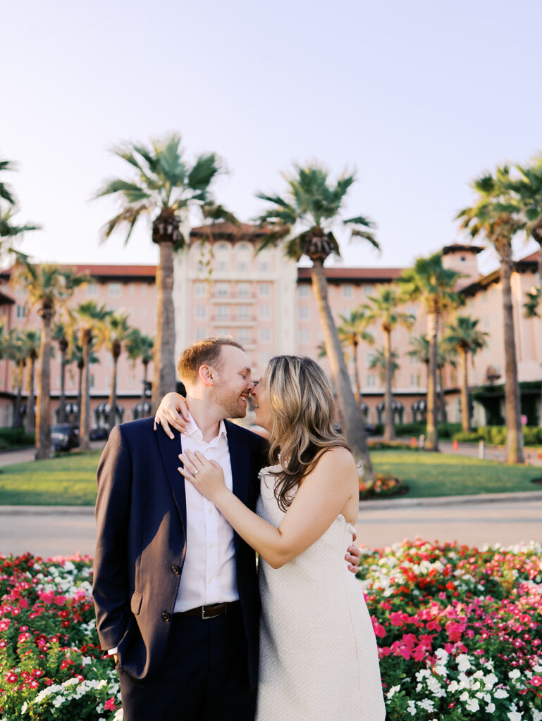 Emma twirling under palm trees while Luke smiles with vibrant timeless color captured on film