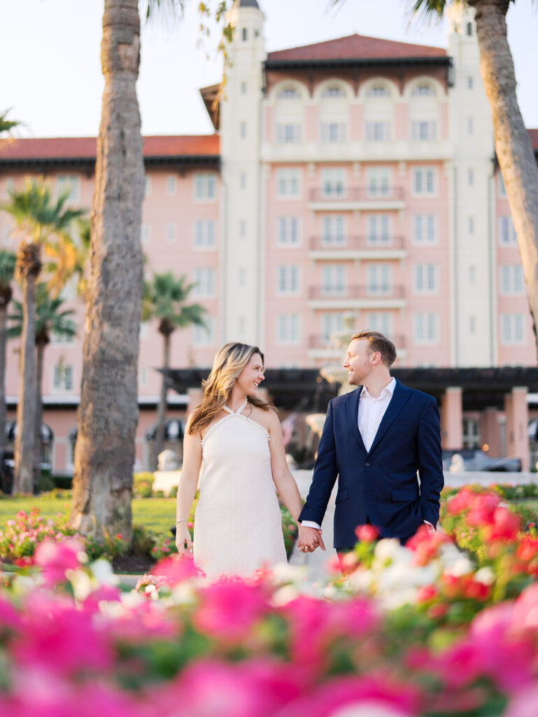 Emma twirling under palm trees while Luke smiles with vibrant timeless color captured on film