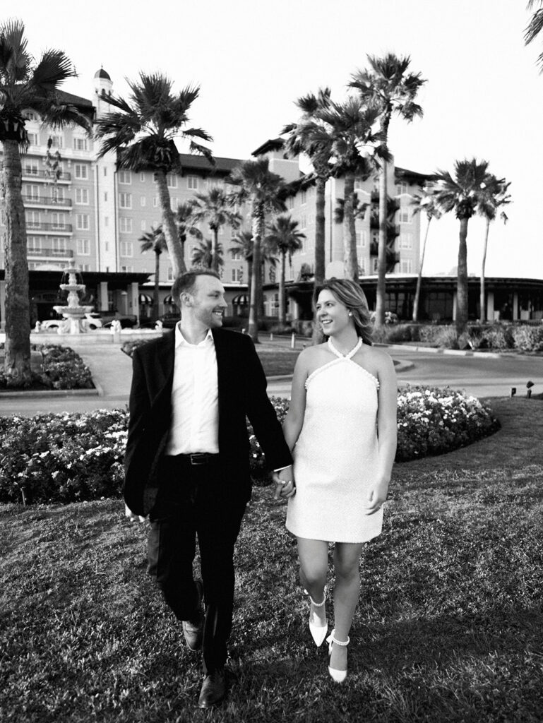 Emma twirling under palm trees while Luke smiles with vibrant timeless color captured on film