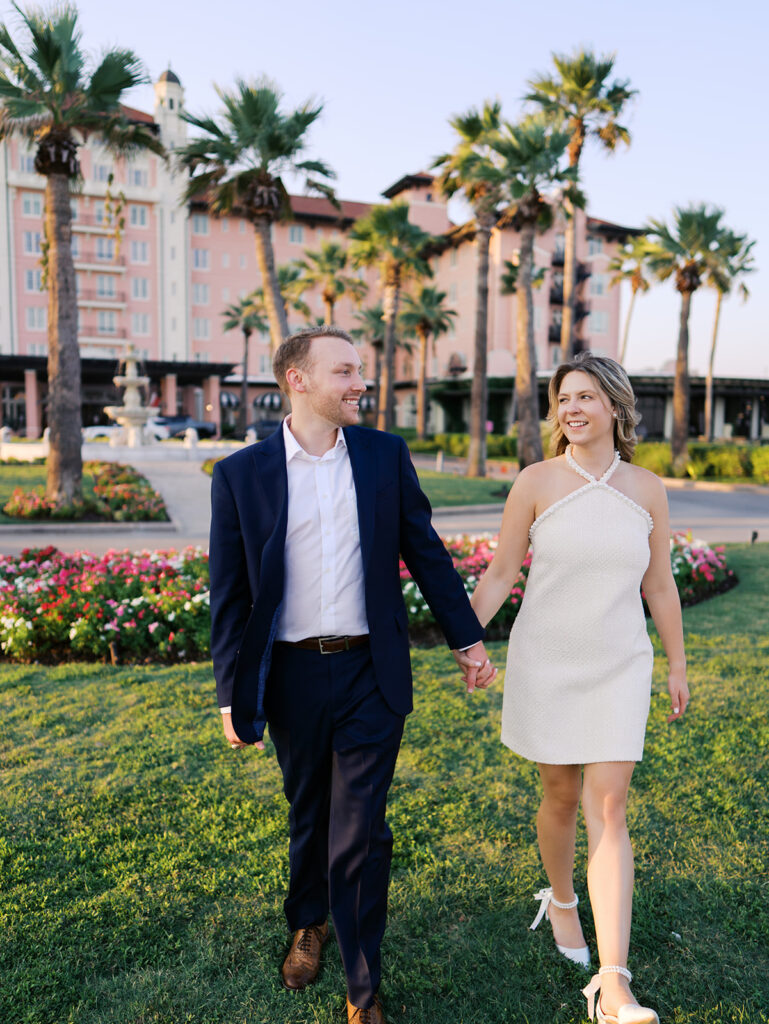 Emma twirling under palm trees while Luke smiles with vibrant timeless color captured on film