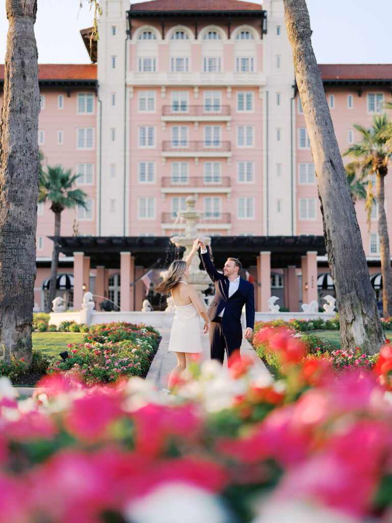 Emma twirling under palm trees while Luke smiles with vibrant timeless color captured on film