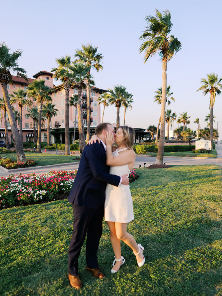 Emma twirling under palm trees while Luke smiles with vibrant timeless color captured on film