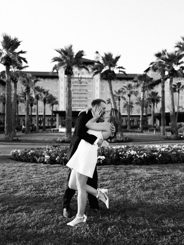 Emma twirling under palm trees while Luke smiles with vibrant timeless color captured on film