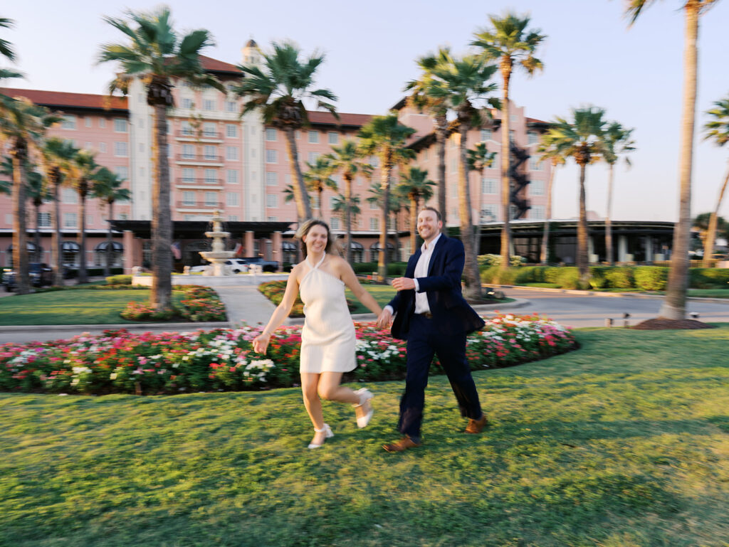 Emma twirling under palm trees while Luke smiles with vibrant timeless color captured on film
