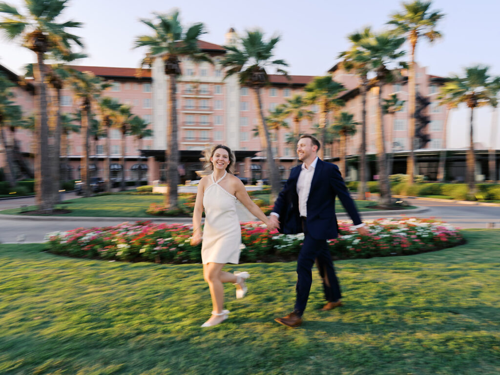 Emma twirling under palm trees while Luke smiles with vibrant timeless color captured on film