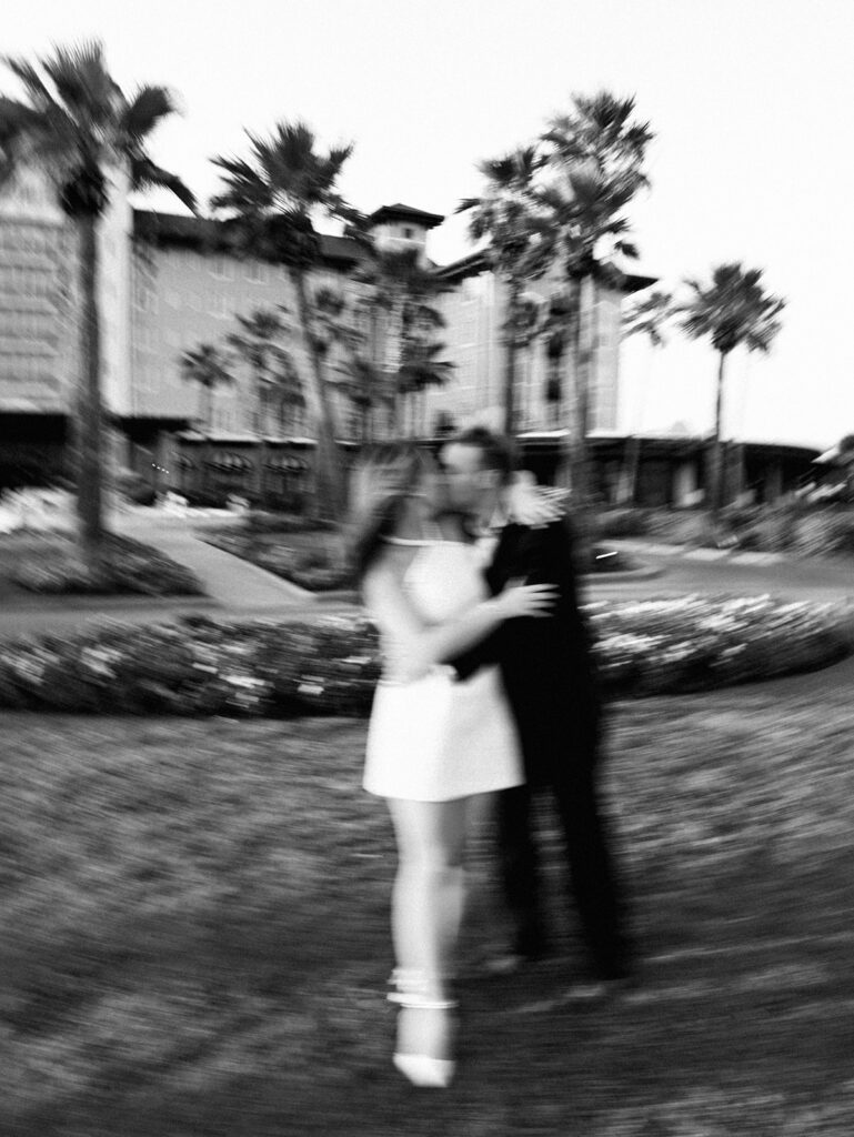 Emma twirling under palm trees while Luke smiles with vibrant timeless color captured on film