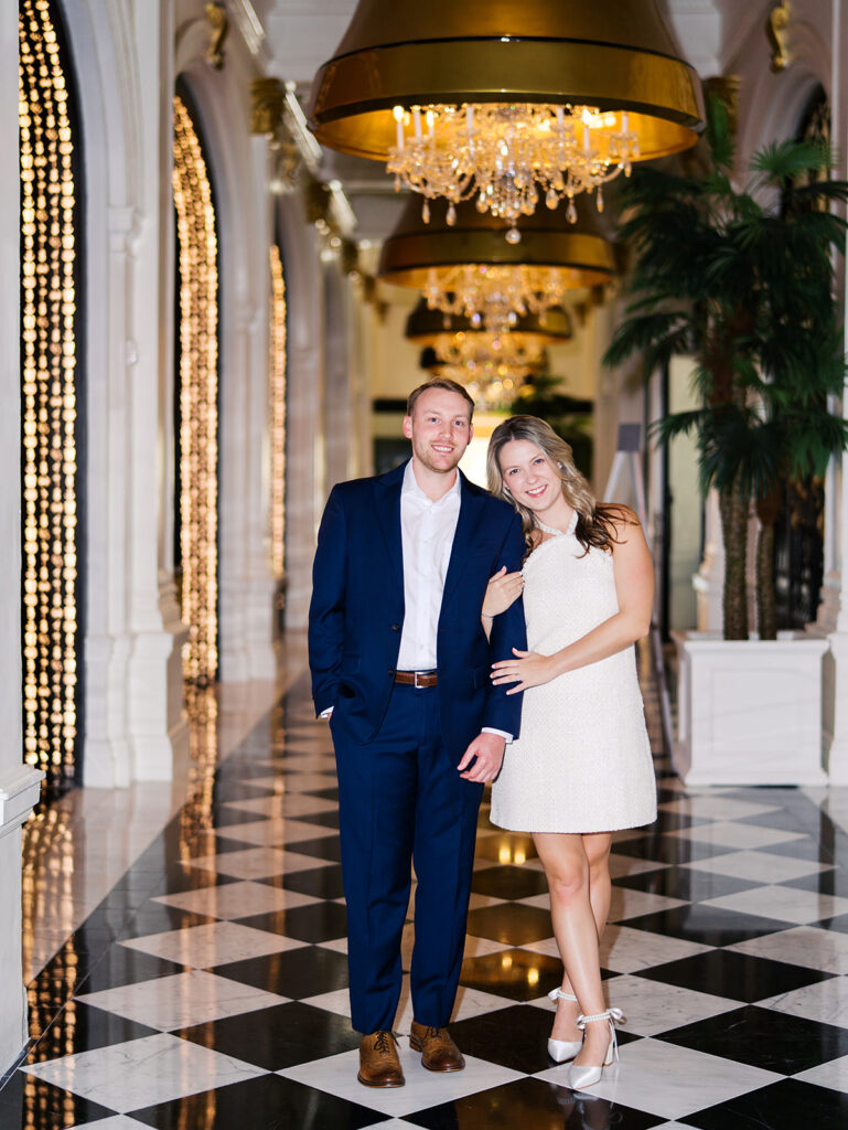 Emma and Luke cheersing and enjoying cocktails at the Grand Galvez bar photographed on film with a relaxed, romantic vibe