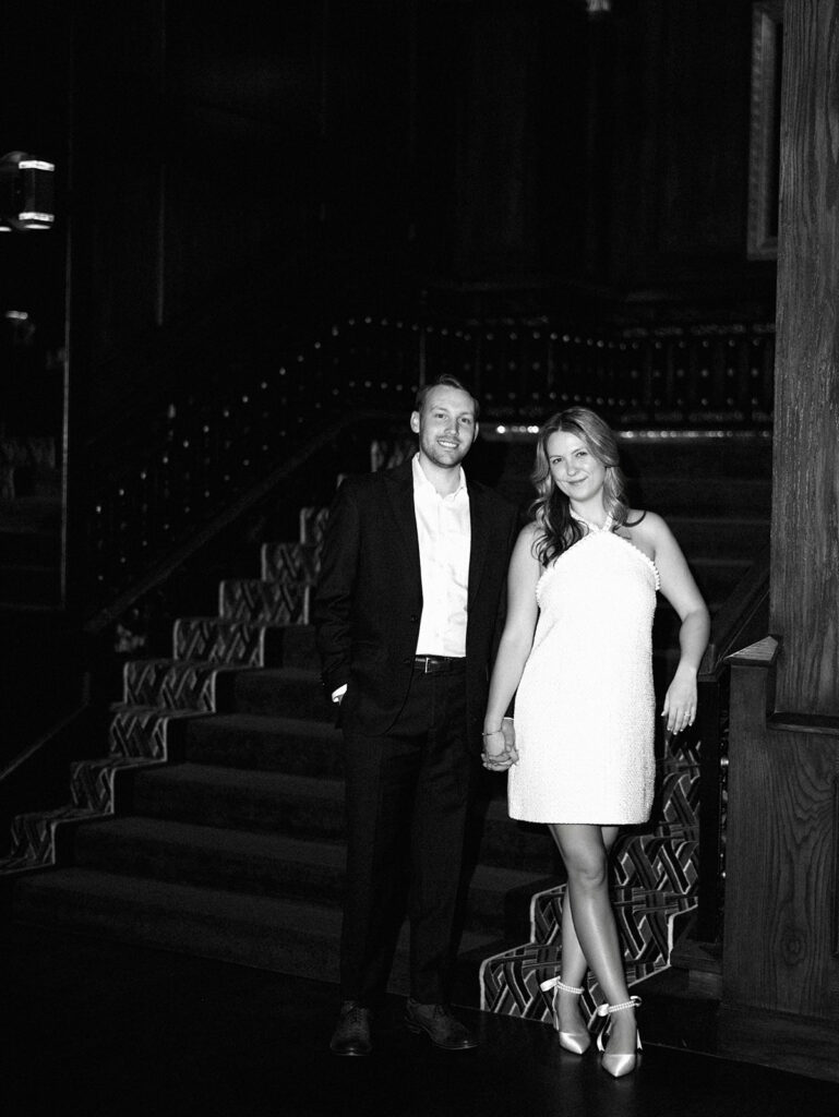 Emma and Luke cheersing and enjoying cocktails at the Grand Galvez bar photographed on film with a relaxed, romantic vibe