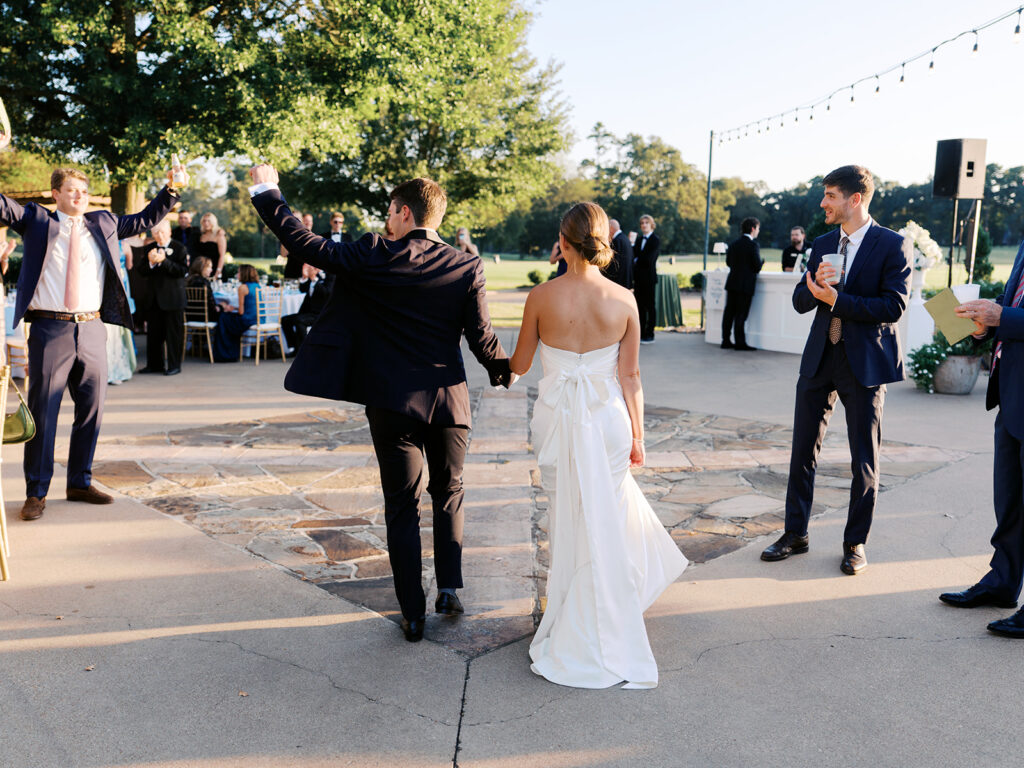 Candid moments during cocktail hour at Texas country club wedding