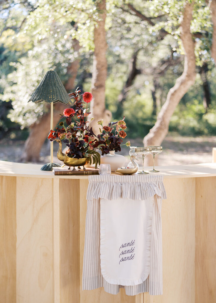 Floral installation by By Maggie Peterson with rich amber, rust, and blush tones