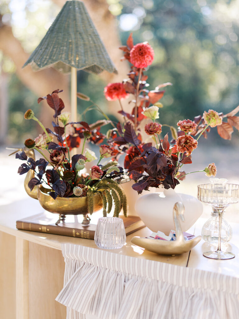 Floral installation by By Maggie Peterson with rich amber, rust, and blush tones