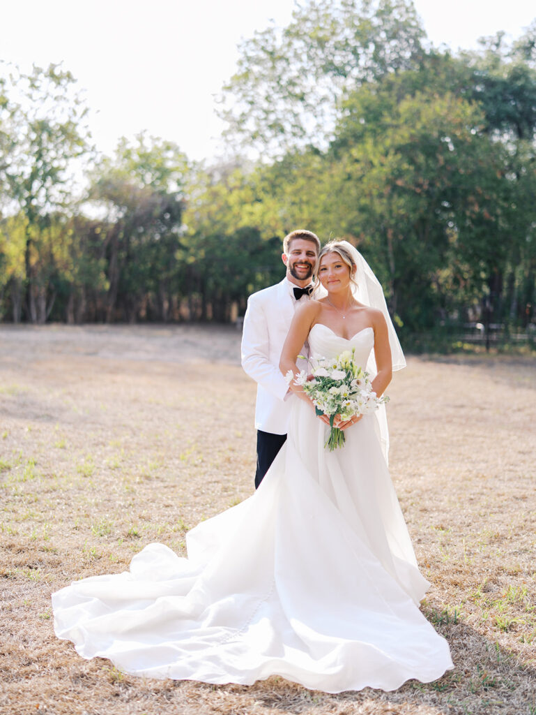 Joyful couple walking through garden at The Winfield Inn wedding