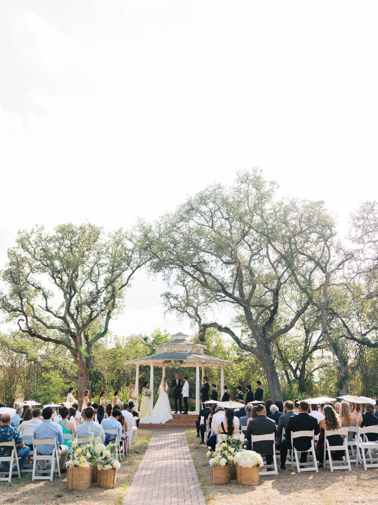 Outdoor ceremony under oak trees at The Winfield Inn in Austin