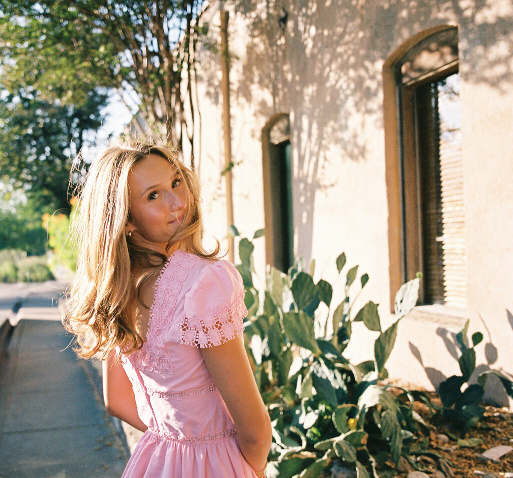 Austin senior photography session with golden sunlight and city views on South Congress