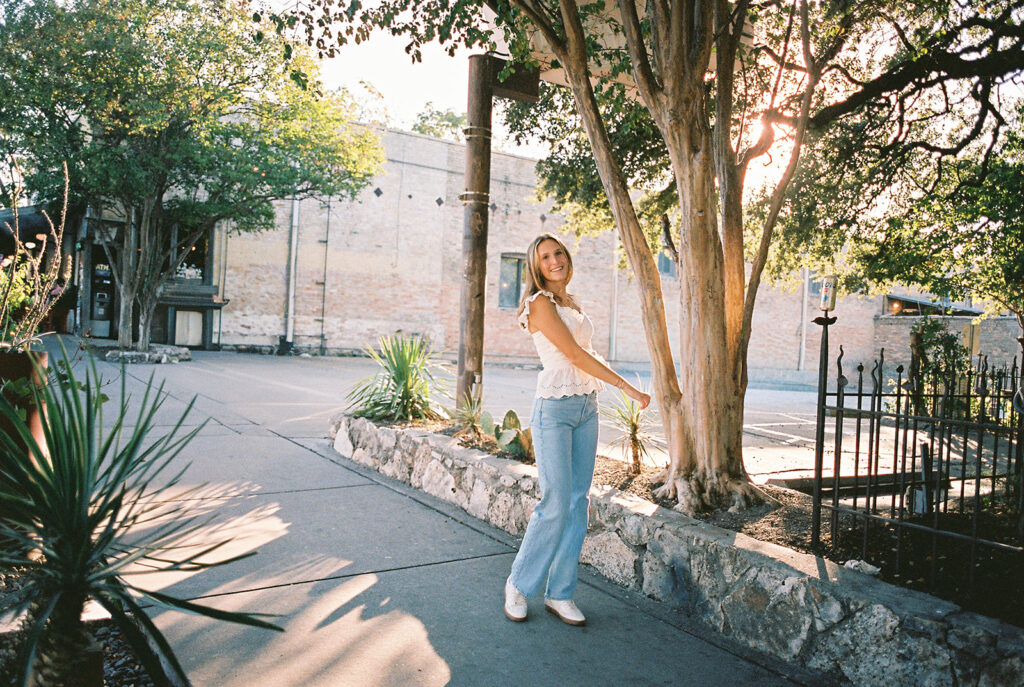 Joyful Austin senior photo on South Congress at golden hour on film