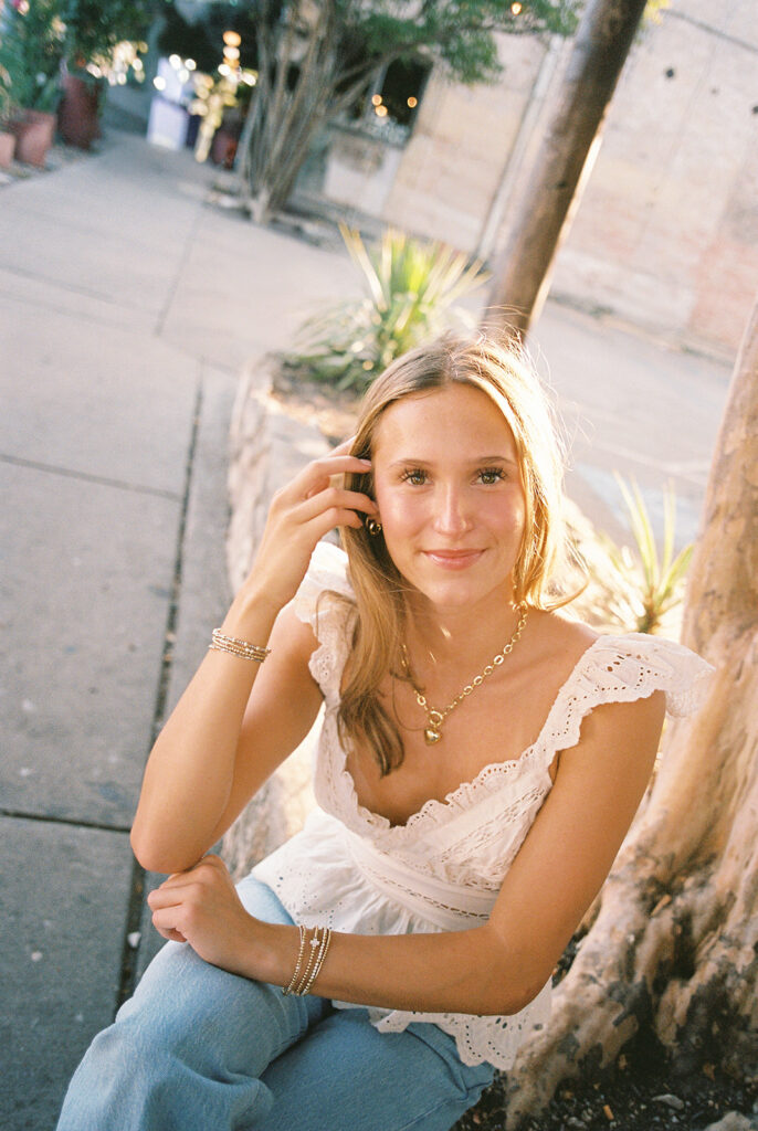 Joyful Austin senior photo on South Congress at golden hour on film