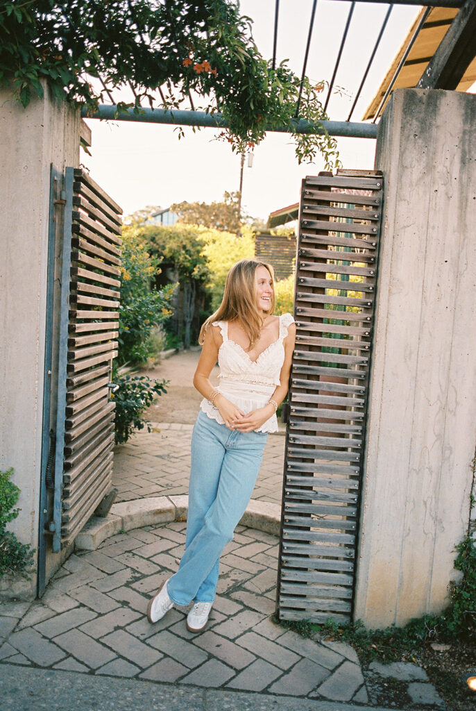 Joyful Austin senior photo on South Congress at golden hour on film