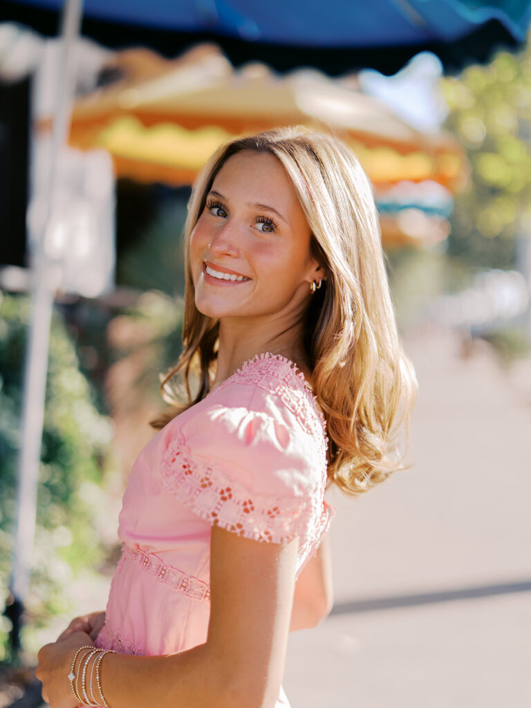 Austin senior photography session with golden sunlight and city views on South Congress