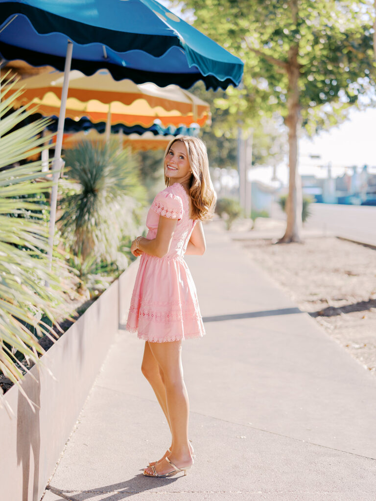 Austin senior photography session with golden sunlight and city views on South Congress