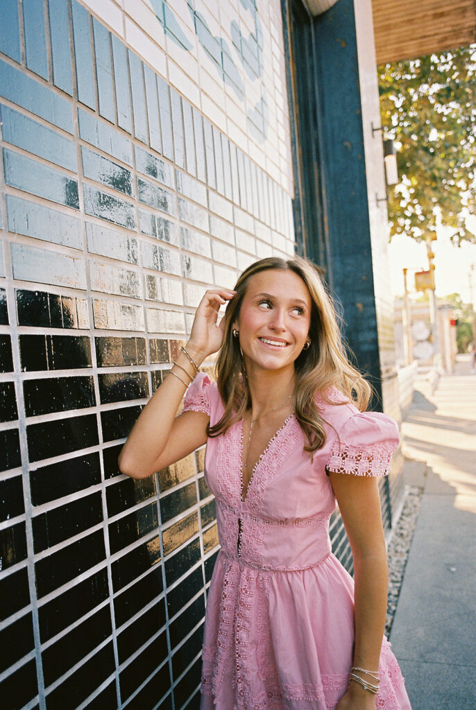 Austin senior photography session with golden sunlight and city views on South Congress