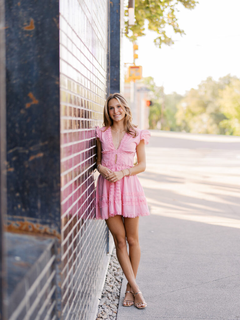 Austin senior photography session with golden sunlight and city views on South Congress