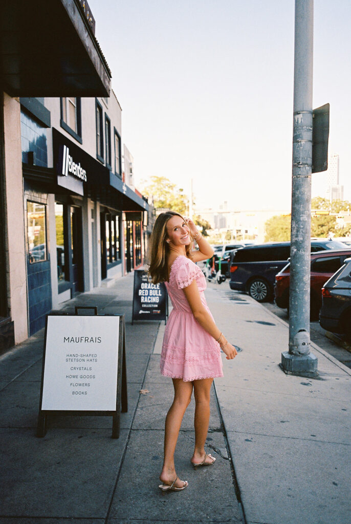 Austin senior photography session with golden sunlight and city views on South Congress