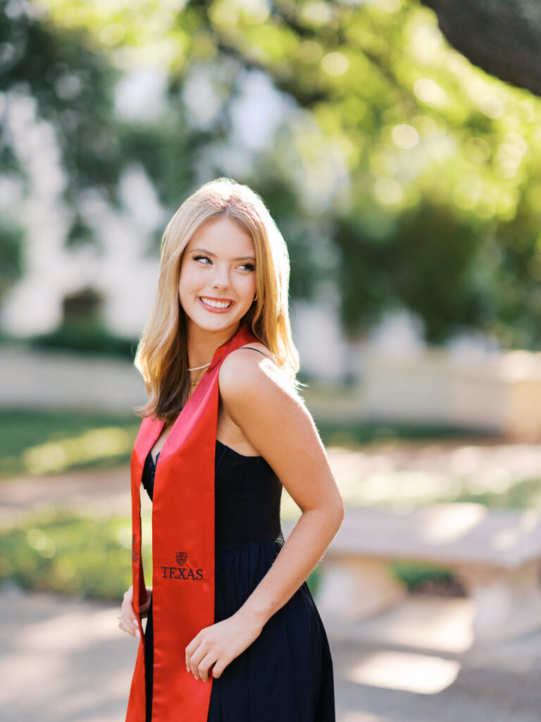 University of Texas grad photos around the UT Austin campus, capturing timeless senior portraits filled with light, laughter, and celebration on film