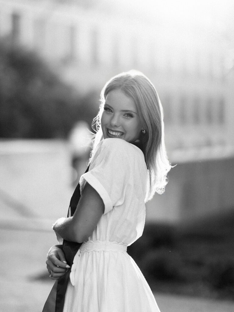 University of Texas grad photos around the UT Austin campus, capturing timeless senior portraits filled with light, laughter, and celebration on film