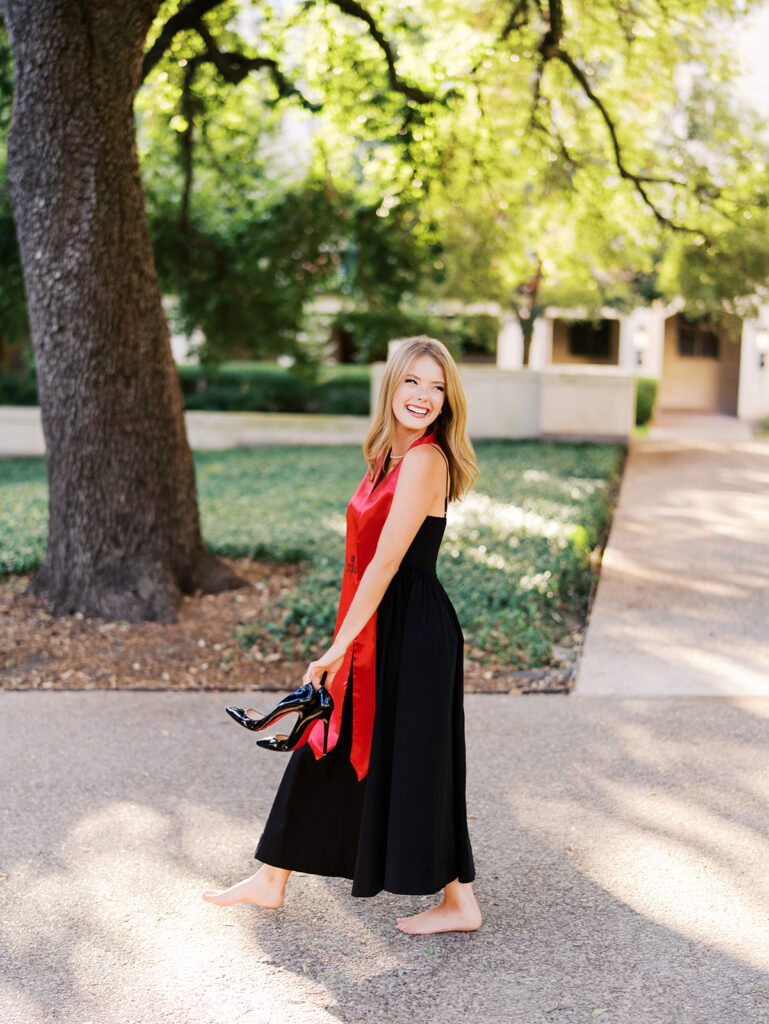 University of Texas grad photos around the UT Austin campus, capturing timeless senior portraits filled with light, laughter, and celebration on film