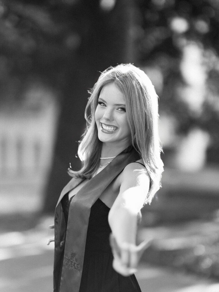 University of Texas grad photos around the UT Austin campus, capturing timeless senior portraits filled with light, laughter, and celebration on film
