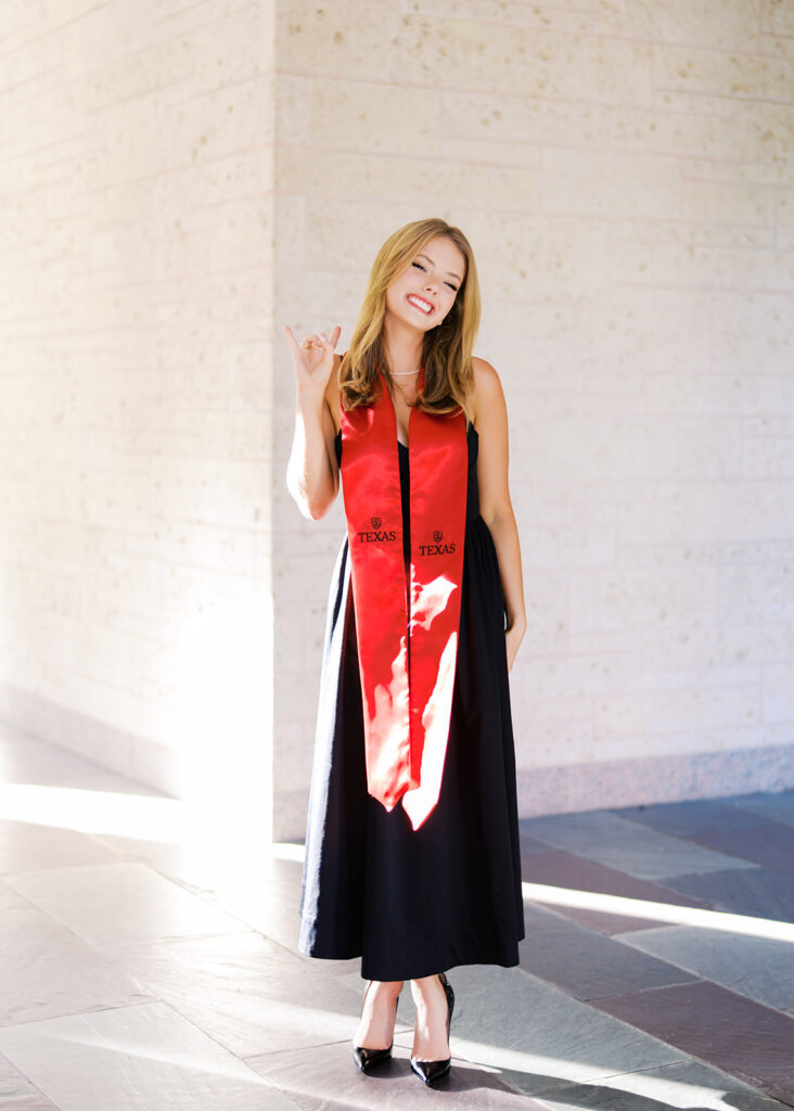 University of Texas grad photos around the UT Austin campus, capturing timeless senior portraits filled with light, laughter, and celebration on film