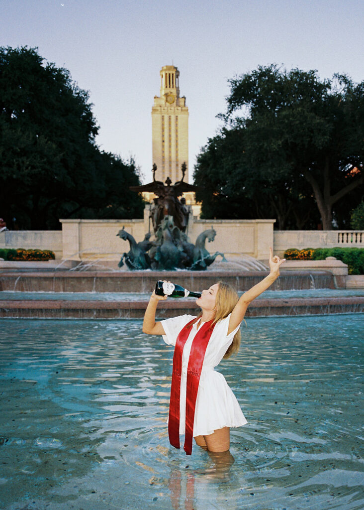 UT Austin grad photos at Littlefield Fountain during golden hour, capturing joyful senior portraits full of color and celebration.