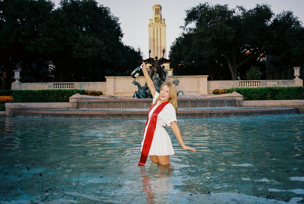 UT Austin grad photos at Littlefield Fountain during golden hour, capturing joyful senior portraits full of color and celebration.
