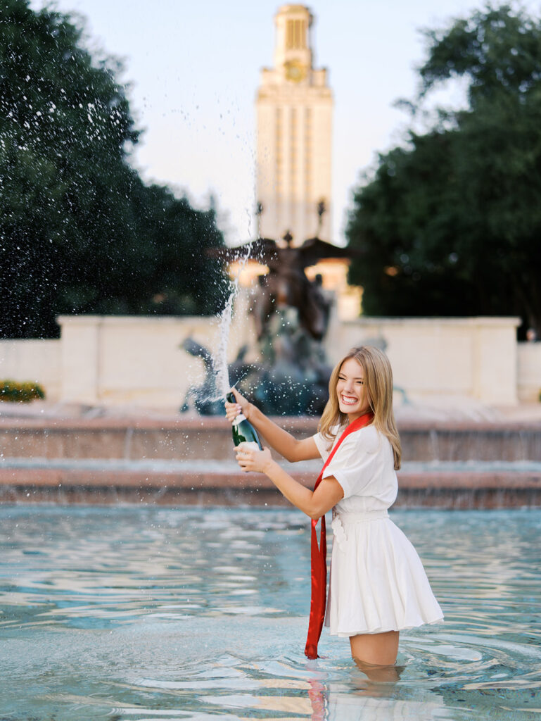 UT Austin grad photos at Littlefield Fountain during golden hour, capturing joyful senior portraits full of color and celebration on film