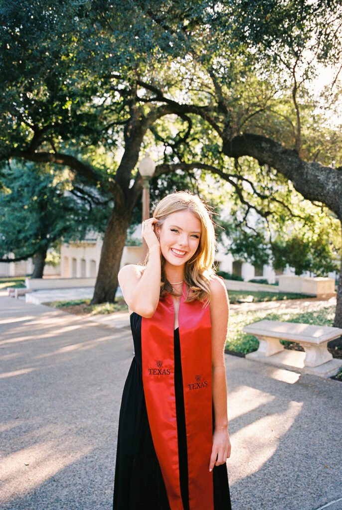 University of Texas grad photos around the UT Austin campus, capturing timeless senior portraits filled with light, laughter, and celebration on film