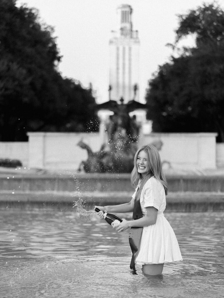 UT Austin grad photos at Littlefield Fountain during golden hour, capturing joyful senior portraits full of color and celebration on film