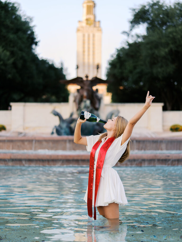 UT Austin grad photos at Littlefield Fountain during golden hour, capturing joyful senior portraits full of color and celebration.