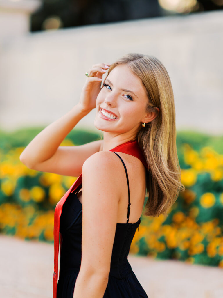 University of Texas grad photos around the UT Austin campus, capturing timeless senior portraits filled with light, laughter, and celebration on film